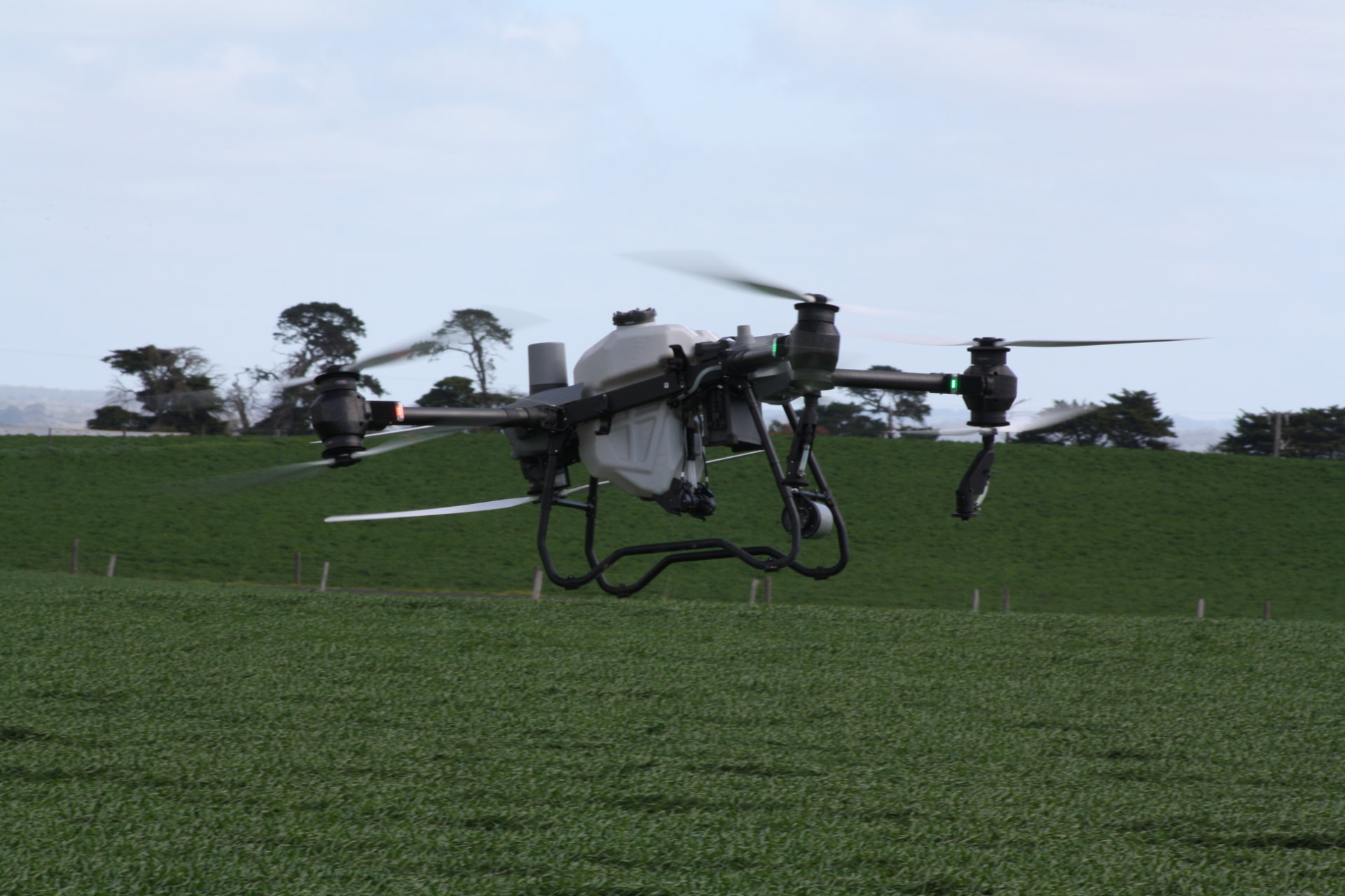 DJI AGRAS drone treating a wet paddock in regional Australia where ground machinery cannot access